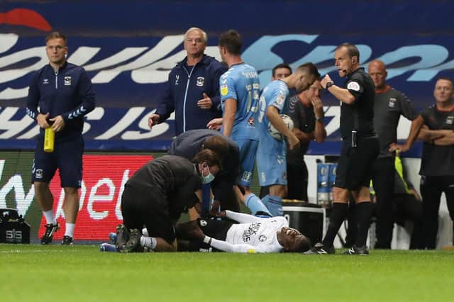 Siriki Dembele went down injured right at the end of the match. Photo: Joe Dent.