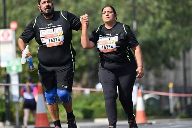 Del Singh running with wife Jas.