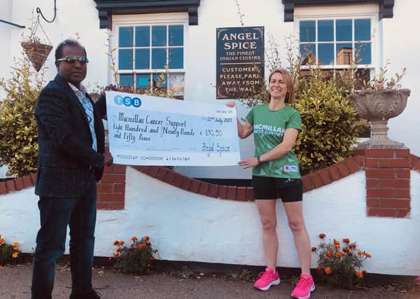 Becky Ford receives a cheque for £890.50 from Abdul Bashir, owner of Angel Spice restaurant in Stilton.