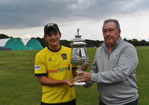 Peterborough Town skipper David Clarke receives the Northants Premier Division trophy from Northants League chairman David Hartley. Photo: David Lowndes.
