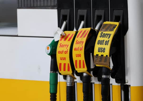 'Out of Use' signage is pictured on the petrol pumps  of a closed fuel filling station.  (Photo by ADRIAN DENNIS/AFP via Getty Images)