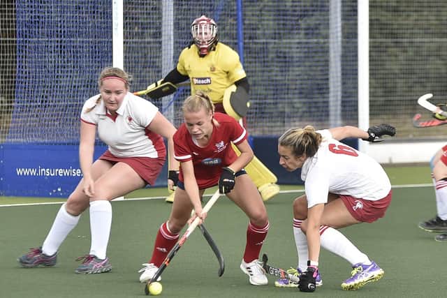 Leone Hart (red) of City of Peterborough Ladies on the ball against Dereham. Photo: David Lowndes.