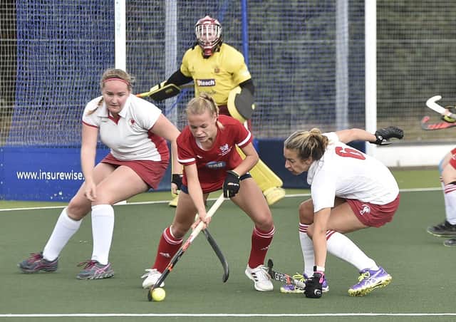 Leone Hart (red) of City of Peterborough Ladies on the ball against Dereham. Photo: David Lowndes.