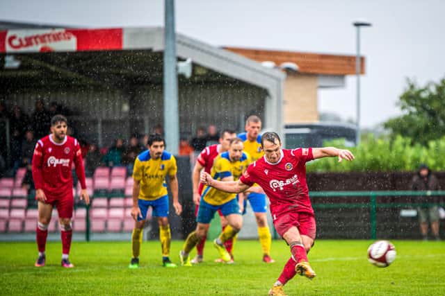 Cameron Johnson scores the penalty that sent Stamford AFC into the fourth qualifying round of the FA Cup on Saturday.