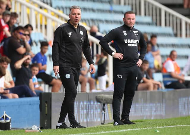 The managers of the bottom two clubs in the Championship Darren Ferguson of Posh and Wayne Rooney of Derby County.