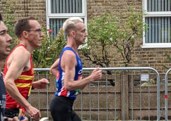 Josh Lunn (right) on his way to 14th place in the London Marathon.