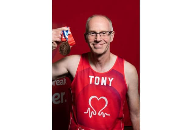Tony Comber with his medal for running the London Marathon.