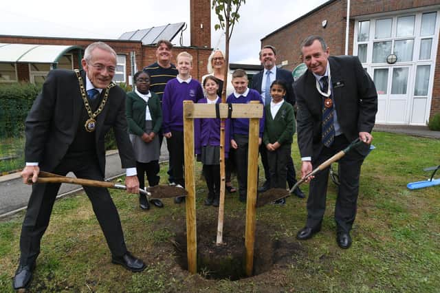 Mayor of Peterborough Steve Lane and Deputy Lieutenant Andrew Riddington with staff, Chair of Governors and pupils at Woodston Primary School planting a tree as part of the "Queen's Green Canopy" project EMN-210510-132820009