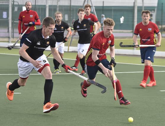 Ross Ambler (red) in action for City of Peterborough HC against Cardiff. Photo: David Lowndes.