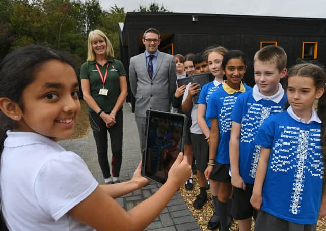 Darren Epton-Smith and Helen Bowers with pupils demonstrating an app used as part of learning about the circulatory system in year 6, embracing the innovative technology within the school  science curriculum.