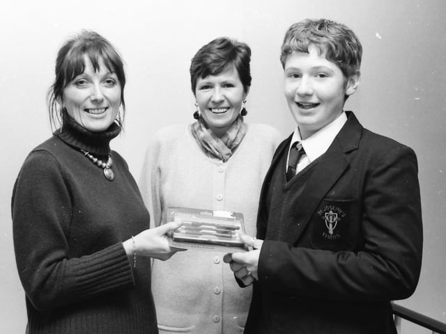 Kieran Coyle, 11N, St. Joseph’s, whose poem ‘Christmas’ was published in a new anthology ‘Poetry Now NI 1997, being presented with a gift from principal, Mrs. Sarah Kelly. Also in the picture is school librarian, Mrs. McCrystal.