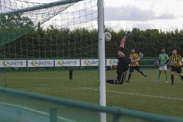 Hamza Akram (green) scores for FC Peterborough v Crowland in a Senior Cup tie. Photo: Tim Symonds