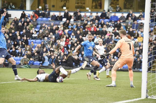 Ricardo Santos (on floor) is about to open the scoring for Bolton at Posh. Photo: David Lowndes.