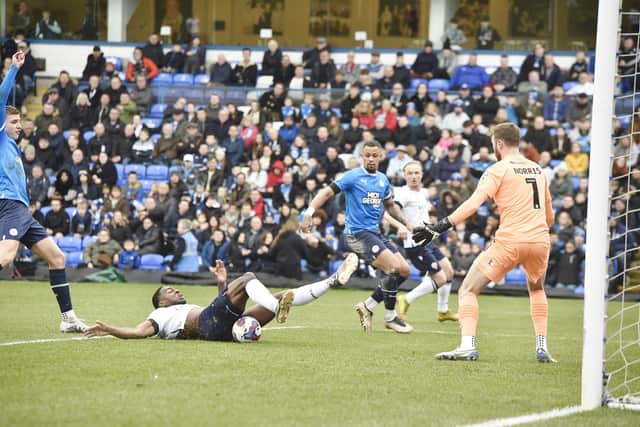 Ricardo Santos (on floor) is about to open the scoring for Bolton at Posh. Photo: David Lowndes.