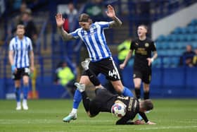 Harrison Burrows of Peterborough United is fouled by Aden Flint of Sheffield Wednesday. Photo: Joe Dent/theposh.com.