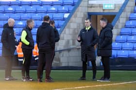Referee Andrew Kitchen (facing) after calling off the Posh v Charlton League One match. Photo: Joe Dent.