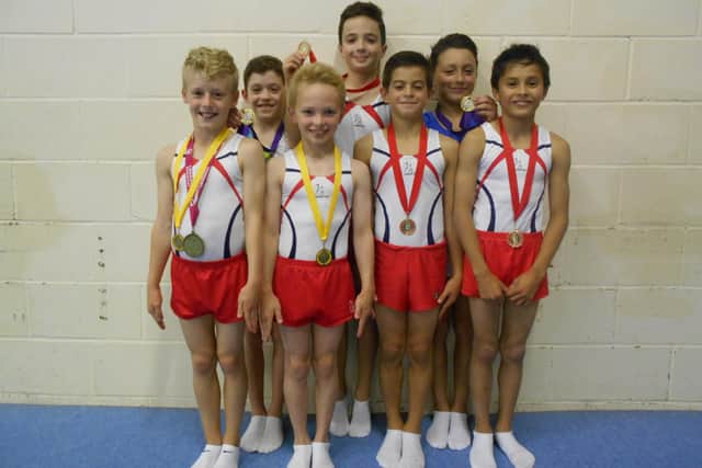 Jake Jarman (right) with Huntingdon Gymnastic Club teammates and their medals in 2014.