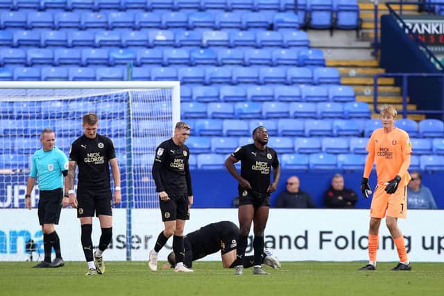 Peterborough United players cut dejected figures after Bolton Wanderers score a late winning goal. Photo: Joe Dent/theposh.com