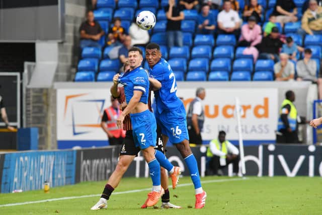 Posh pair David Okagbue and Carl Johnston battle for possession against Bradford City. Photo David Lowndes.