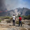 Wildfires north of the coastal town Gennadi, in the southern part of the Greek island of Rhodes on July 25, 2023. Some 30,000 people fled the flames .