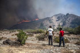 Wildfires north of the coastal town Gennadi, in the southern part of the Greek island of Rhodes on July 25, 2023. Some 30,000 people fled the flames .