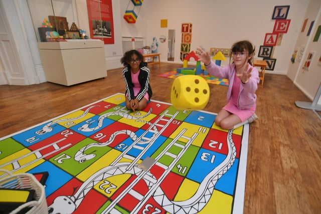 Tyger-Rei Duncan  and Issy Patten playing snakes and ladders.