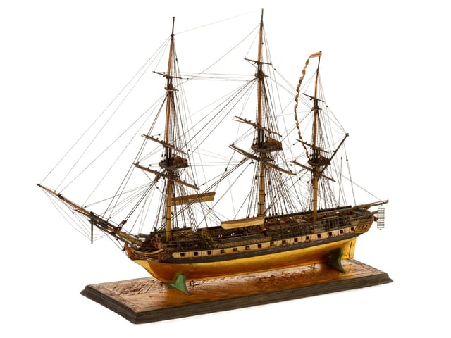 Model of a British Frigate with figurehead of a lady waving a hanky. Made by prisoners of war at the Norman Cross Depot.