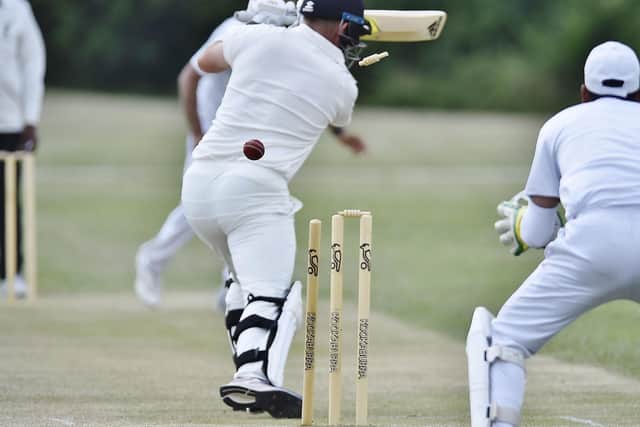 Mark Hodgsonof Burghley Park is bowled by Hassan Ameir of Werrington. Photo: David Lowndes.