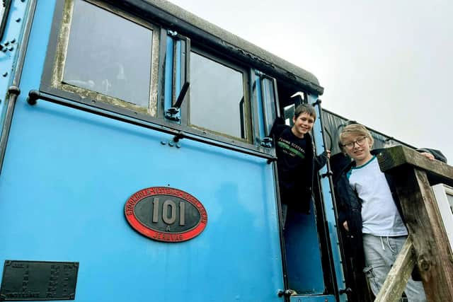 Harry Cowley, 12, and Oliver Walker, 12, stood next to the train used in the James Bond Octopussy film, which Nene Valley Railway is famous for (image: SWNS)