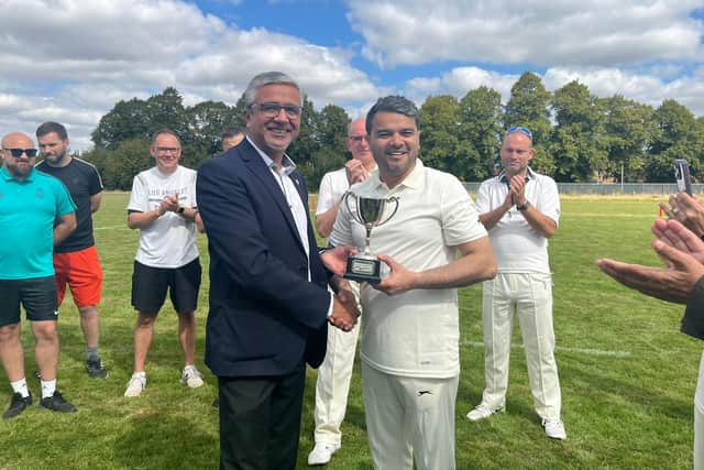 Councillor Amjad Iqbal receives the trophy. Photo: PCC.