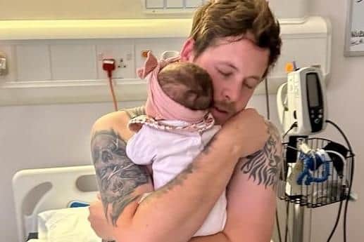 Sam Bravo-Hibberd in hospital with his daughter Alejandria