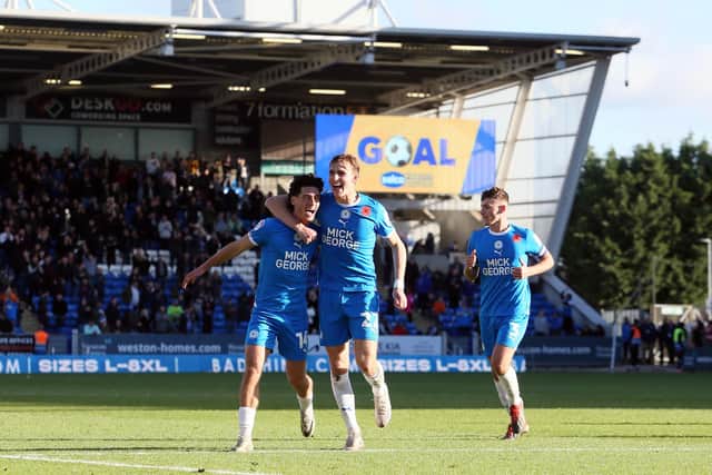 Peterborough United players celebrate the fifth goal against Cambridge United. Photo: Joe Dent.