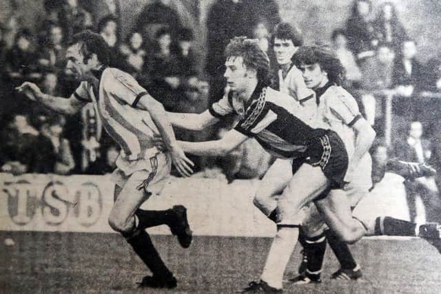 Posh legend Tommy Robson (left) playing against Cambridge United in 1977.