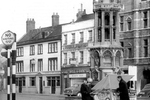 Market Square in the 1960s showing the Greyhound Pub (left) sitting alongside the Bell & Oak with a Wimpy bar sitting right next door or, seemingly, downstairs. The News of the World is advertising 'The truth about wrestling’s muscle men” - a scandal brewing... (image: Peterborough Images Archive)