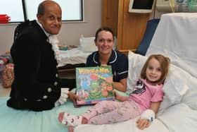 High Sheriff of Cambridgeshire Dr Barat Khetani presenting Christmas gifts for children in the Amazon Ward at City Hospital with Sister Erika Davies and young patient Sophie Stapleton (6).