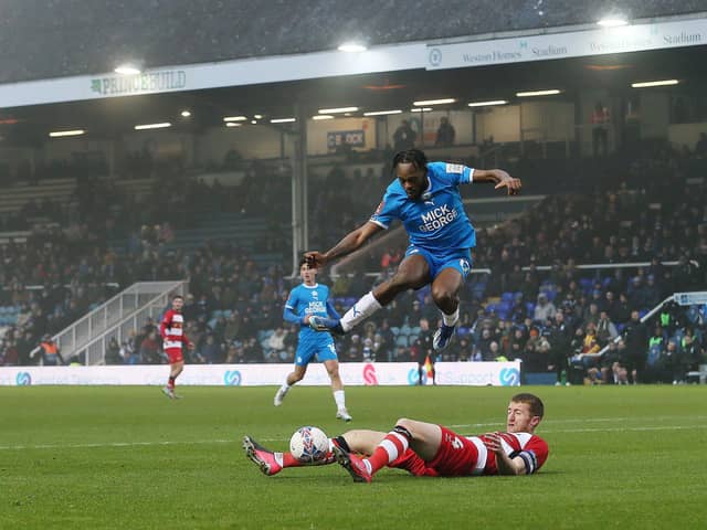 Ricky-Jade Jones of Peterborough United skips over a challenge from Tom Anderson of Doncaster Rovers. Photo: Joe Dent/theposh.com.