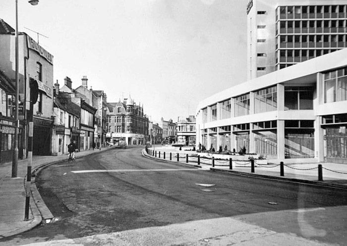A fusion of the old (left) with the new (right) on a quiet Midgate. This photo is undated although it's thought to be some time around the early 1980s (image: Peterborough Images Archive)