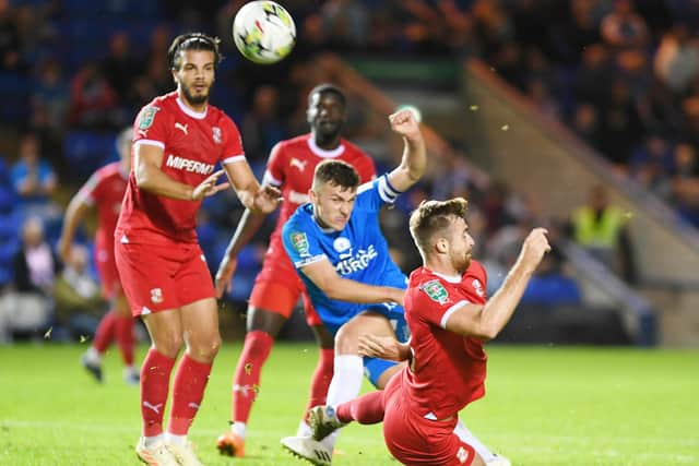 Posh skipper Harrison Burrows shoots over the bar against Swindon. Photo: David Lowndes.