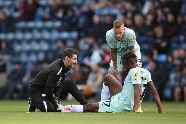 Ricky-Jade Jones of Peterborough United receives treatment after getting injured at Wycombe. Photo: Joe Dent/theposh.com.