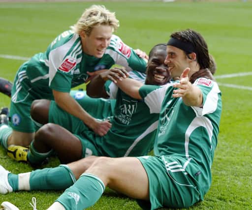 From the left, Craig Mackail-Smith, Aaron Mclean and George Boyd celebrate a Posh goal.