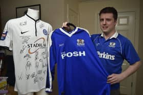 Nick Warrick with his collection of shirts worn by Posh at Wembley - the Johnstone Paints final 2014, Div 3 Playoffs 2000 and Div 2 Playoffs 1992 - will this year's kit join the collection of winning Wembley shirts?
