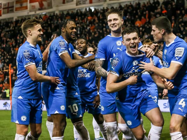 Harrison Burrows (second right) celebrates his first goal for Posh at Blackpool.