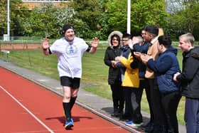 Jason Lovett doing a super marathon at the Embankment track -  cheered on by Heltwate School pupils
