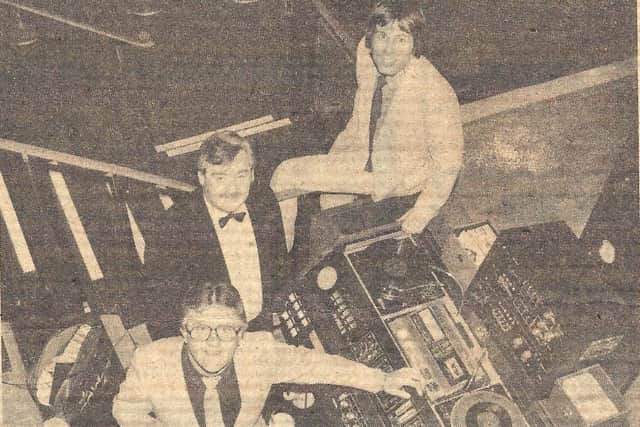 A newspaper cutting featuring manager John Oliver with DJs Tom Bryan and Ben Calhoun