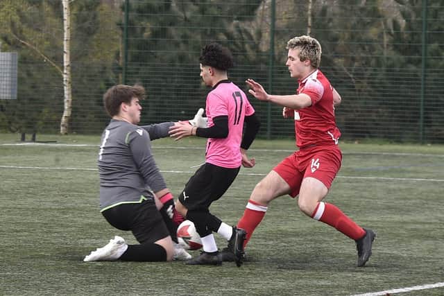 Action from Hampton Under 18s v Stamford (red). Photo David Lowndes.