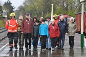 Volunteer firefighters Kevin Duke and Sam Pumpr, Deputy Mayor Nick Sandford and Deputy Mayoress Bella Saltmarsh with sponsored walkers Harry Cowley and Oliver Walker and their supporters -  raising funds for the repair of the fire-damaged signal box at Orton Mere.