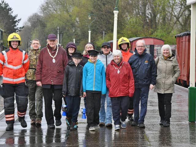 Volunteer firefighters Kevin Duke and Sam Pumpr, Deputy Mayor Nick Sandford and Deputy Mayoress Bella Saltmarsh with sponsored walkers Harry Cowley and Oliver Walker and their supporters -  raising funds for the repair of the fire-damaged signal box at Orton Mere.
