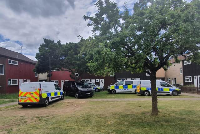 Police vehicles are parked outside the scene of the incident (image: NationalWorld)