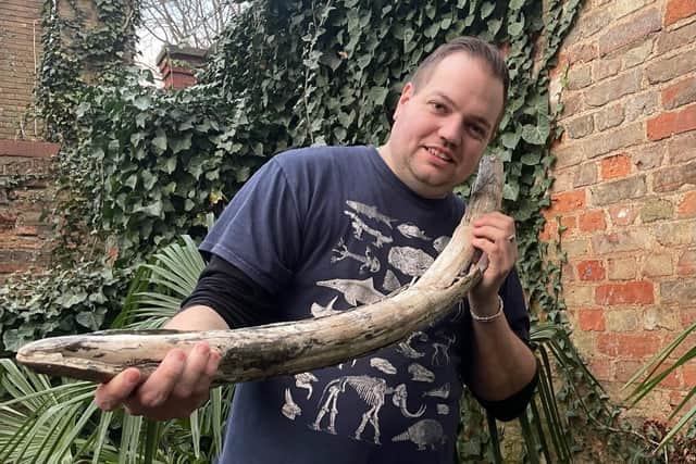Palaeontologist Jamie Jordan with the "fully-preserved" tusk of a juvenile mammoth which once roamed our region during the Ice Age.