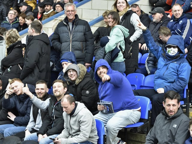 Peterborough United fans are pictured watching the crucial win over Derby County.